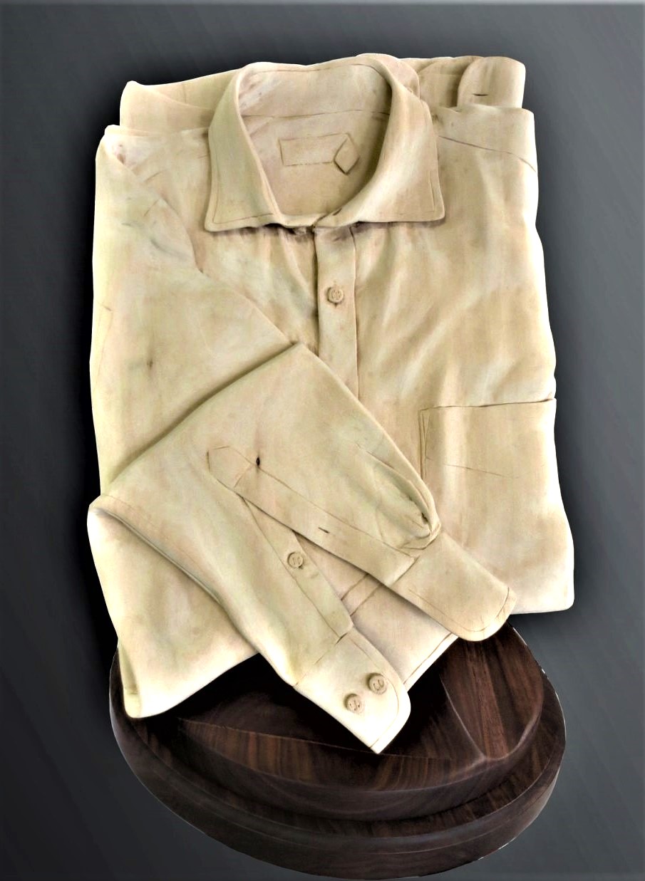 Carved shirt sculpture on pedestal stand